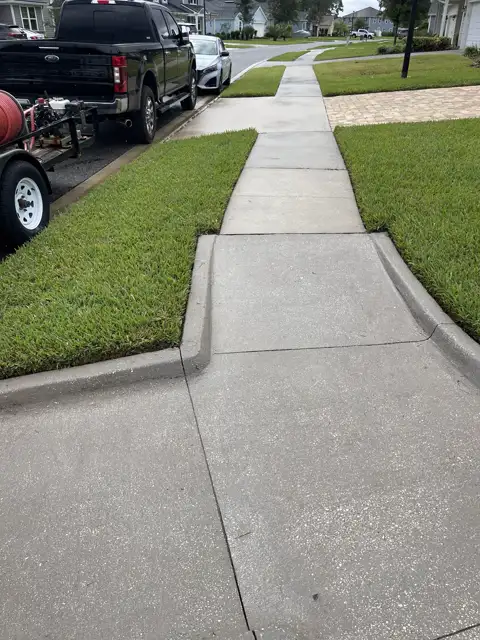 Clean sidewalk after pressure washing by The Stream Team